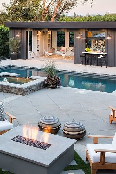 Luxury backyard pool and outdoor lounge with fire pit and pool house pavilion.